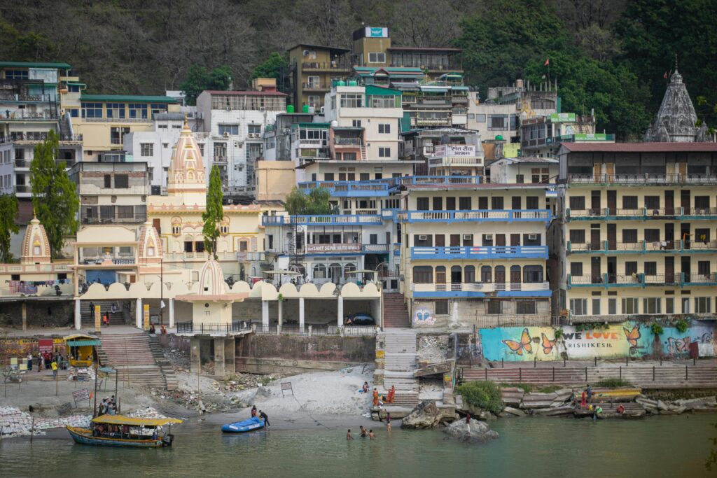 Vibrant buildings along the Ganges River in Rishikesh, India. A bustling urban scene with cultural charm.