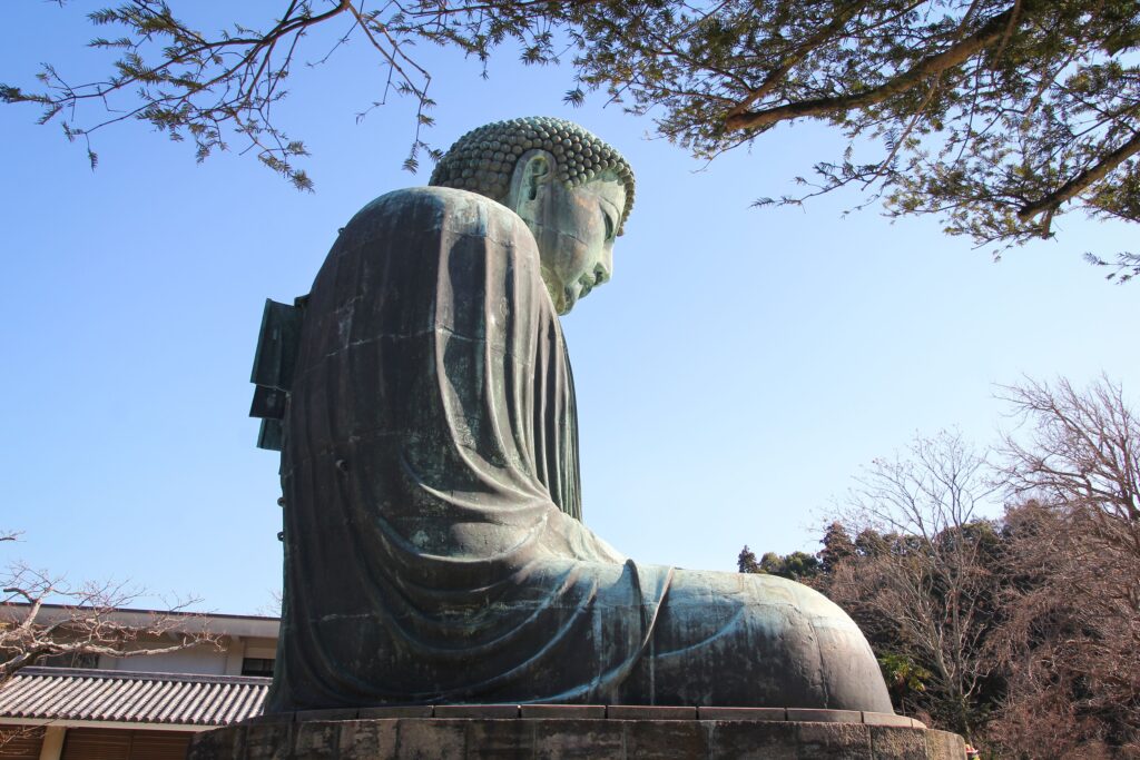 Best Places to Visit in Japan in 2026: 25 Amazing Must-See Gems View of the Great Buddha statue in Kamakura, Japan, under a clear blue sky.