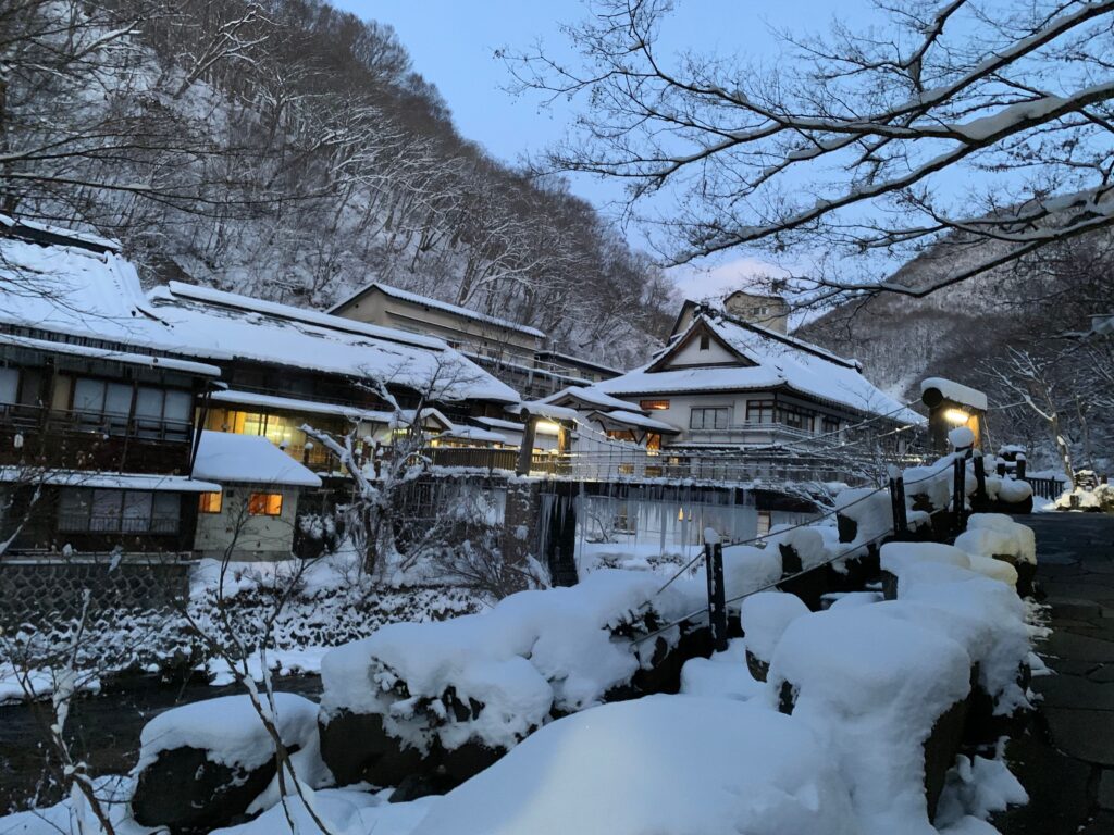 Best Places to Visit in Japan in 2026: 25 Amazing Must-See Gems Charming snow-covered village in Takayama, Japan, captured at twilight, showcasing serene winter beauty.