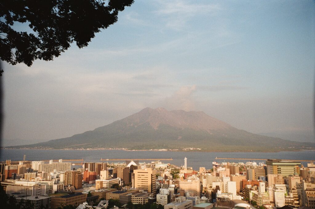 Best Places to Visit in Japan in 2026: 25 Amazing Must-See Gems Dramatic view of Kagoshima cityscape with Sakurajima volcano in Japan.