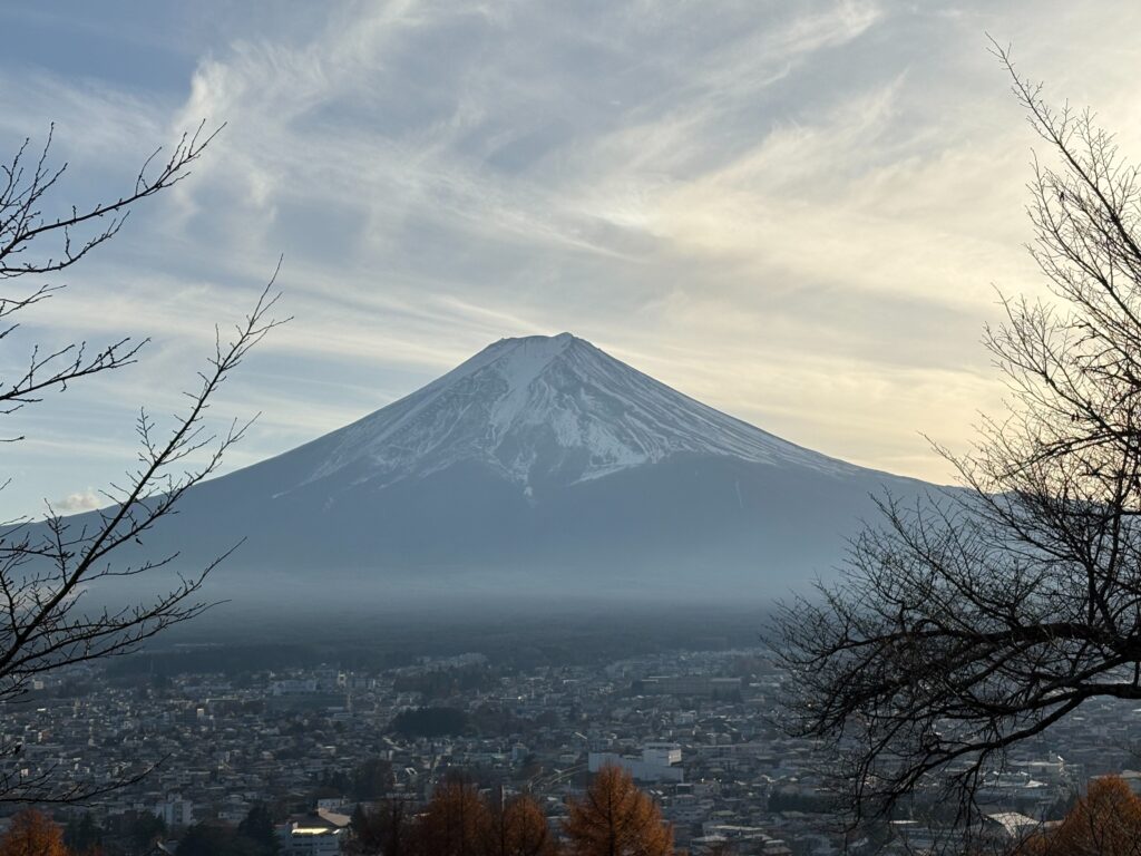 Best Places to Visit in Japan in 2026: 25 Amazing Must-See Gems Stunning view of Mount Fuji with a serene cityscape at dusk, surrounded by nature.