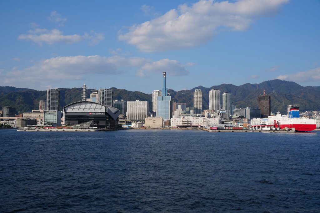 Best Places to Visit in Japan in 2026: 25 Amazing Must-See Gems Skyline view of Kobe, Japan featuring the port and cityscape against clear blue skies.