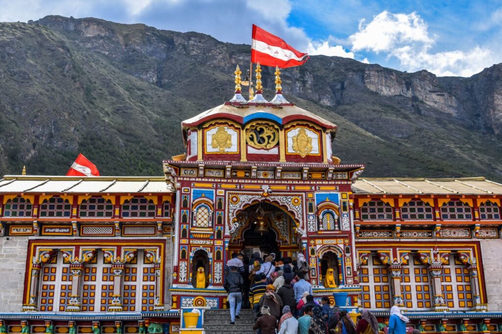 Sacred Places Every Hindu Should Visit – Ultimate Divine Guide Vibrant view of Shree Badrinath Temple with pilgrims gathered around, set against a mountainous backdrop.