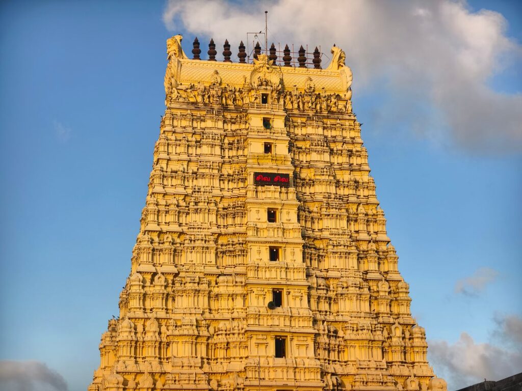 Sacred Places Every Hindu Should Visit – Ultimate Divine Guide Magnificent view of Rameswaram temple gopuram with intricate carvings under clear blue sky.