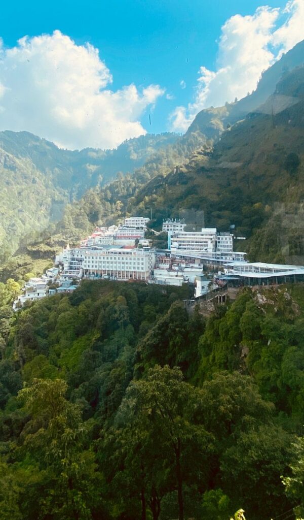 Sacred Places Every Hindu Should Visit – Ultimate Divine Guide A breathtaking aerial view of Vaishno Devi temple surrounded by lush green mountains in Katra, India.