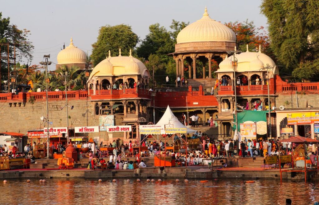Sacred Places Every Hindu Should Visit – Ultimate Divine Guide Bustling evening at Ram Ghat with pilgrims and vibrant architecture in Ujjain, India.